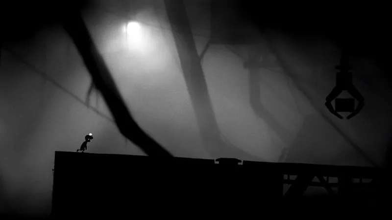 A screenshot of LIMBO showing the boy pushing a cart to overcome an obstacle.