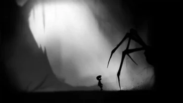 A silhouetted boy standing in a dark forest with looming trees and a hazy background.